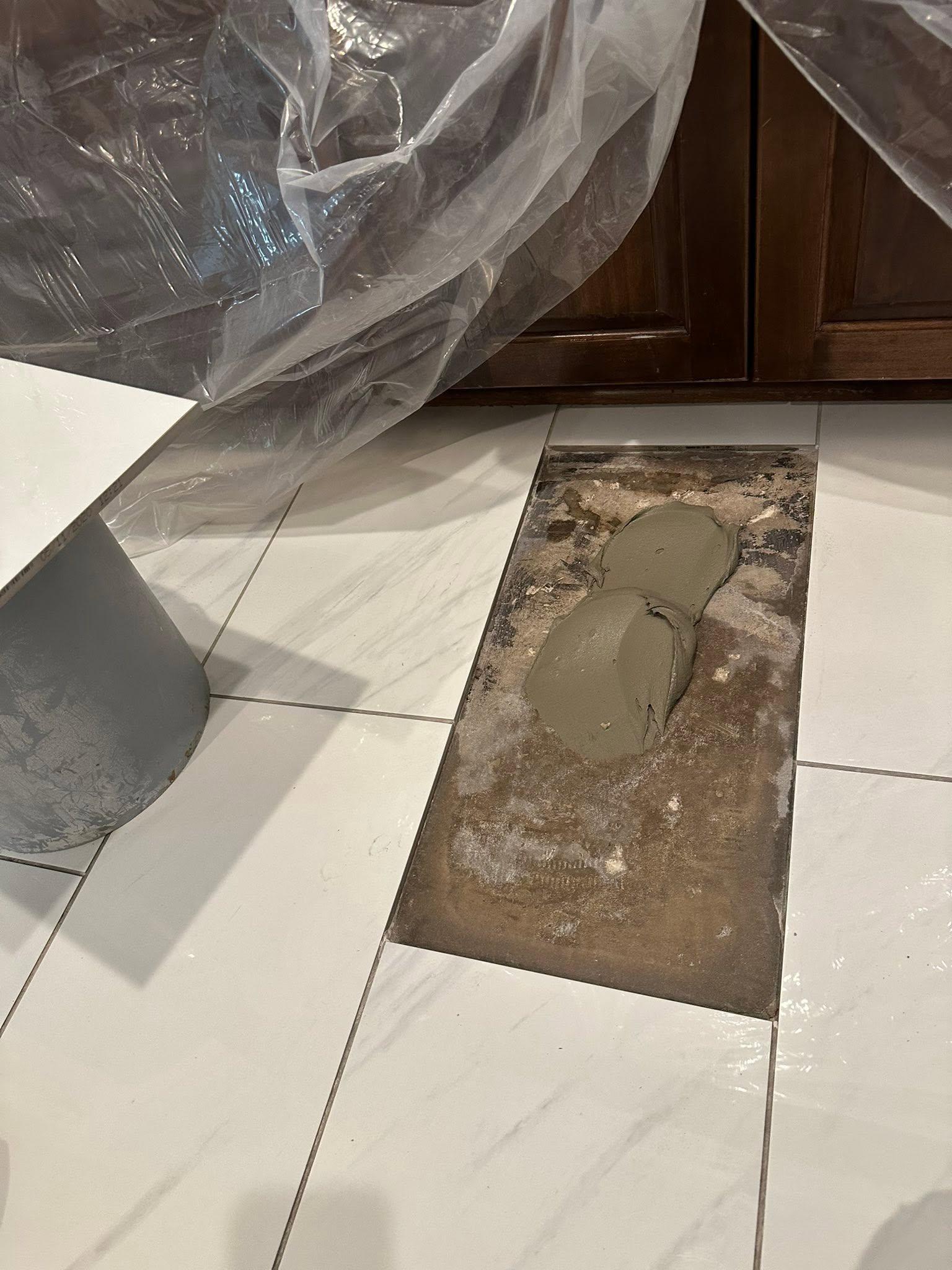 Damaged tile removed and patched with fresh mortar, ready for a replacement tile